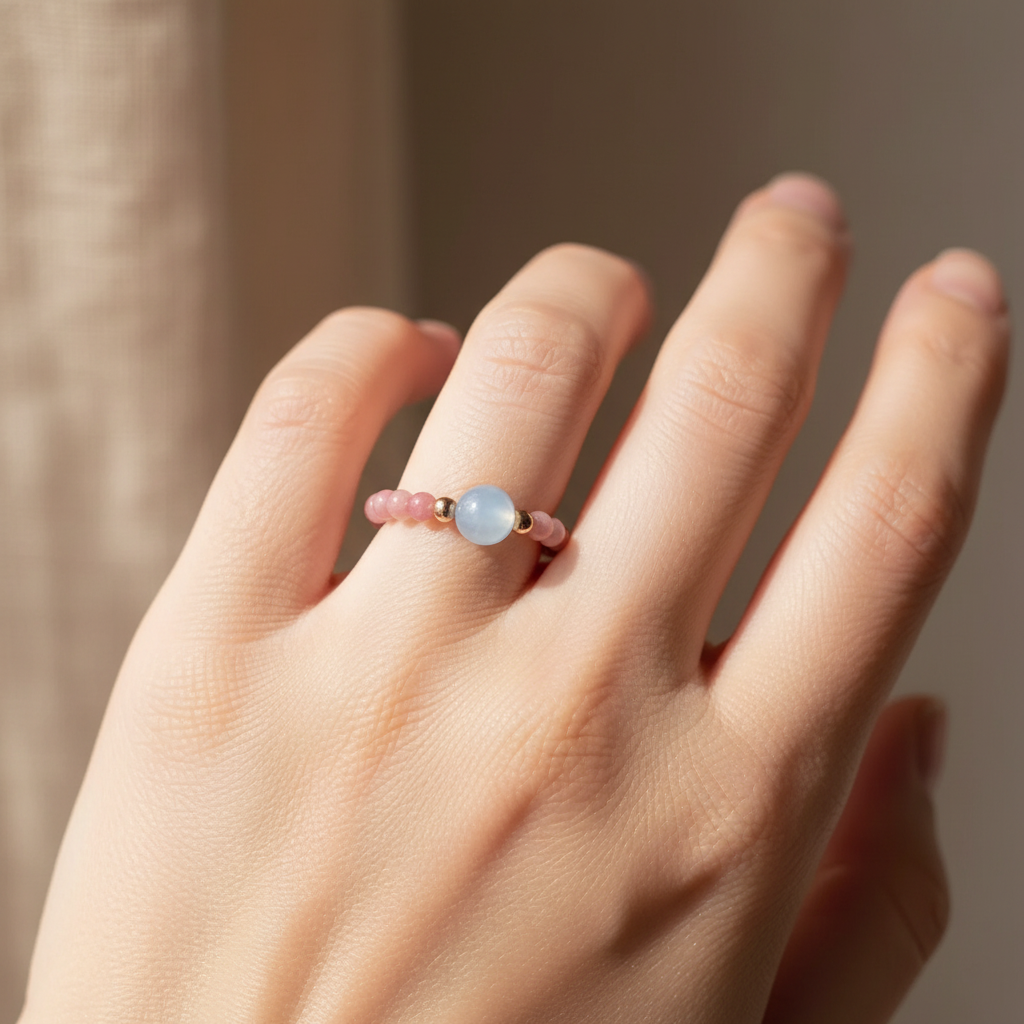 Rhodonite ring worn on hand — natural window light