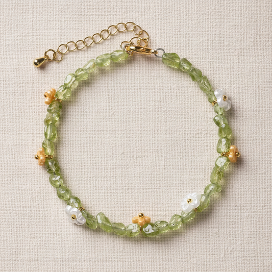 Peridot bracelet full circle flat lay on warm cream linen