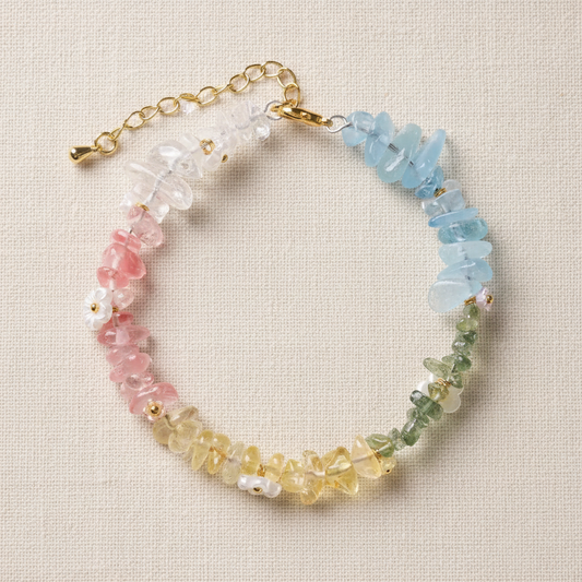 Rainbow crystal bracelet full circle flat lay on warm cream linen