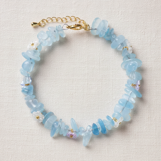 Aquamarine bracelet full circle flat lay on warm cream linen