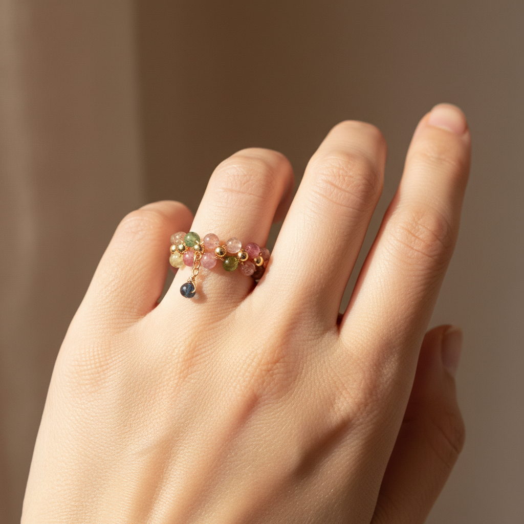 Tourmaline ring worn on hand — natural window light
