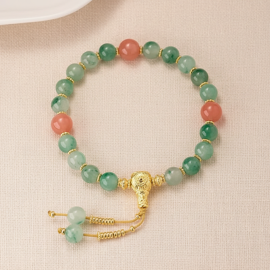 Green aventurine bracelet full circle flat lay on warm cream linen